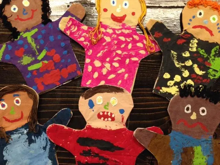 Colorful handmade story characters arranged on a classroom wall.